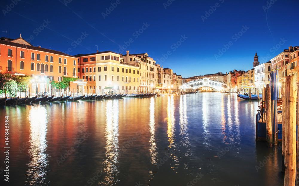 City landscape. Rialto Bridge Ponte Di Rialto in Venice, Italy at night. Many tourists visiting the beauty of the city throughout the year