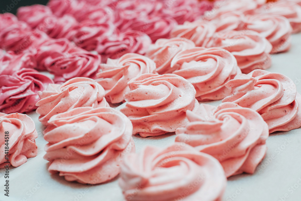 Homemade marshmallows pink on a white parchment Homemade marshmallows pink on a white parchment