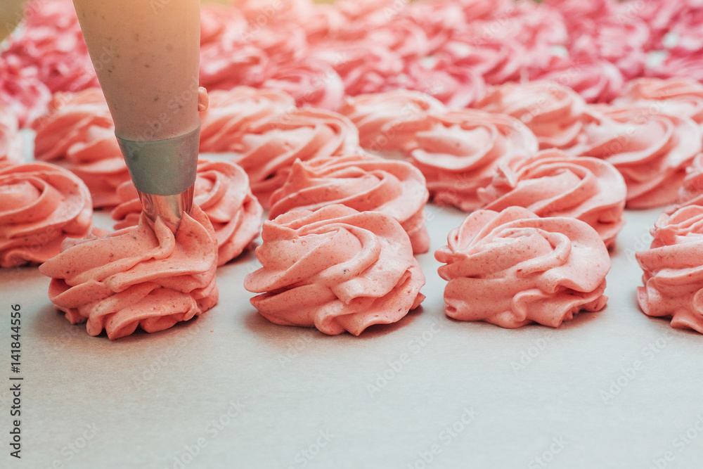 Homemade marshmallows pink on a white parchment Homemade marshmallows pink on a white parchment