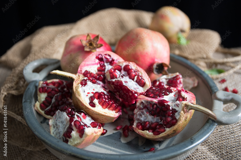 Pomegranate fruit arranged on wooden table top Pomegranate fruit arranged on wooden table top