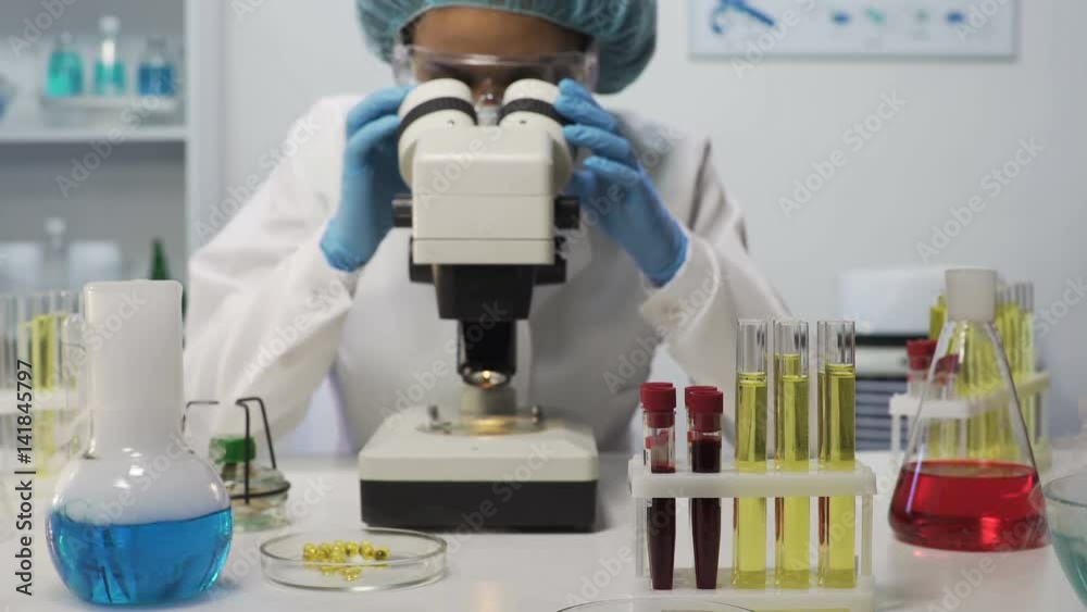 Female lab assistant doing biochemical research, experimental medicine Female lab assistant doing biochemical research, experimental medicine