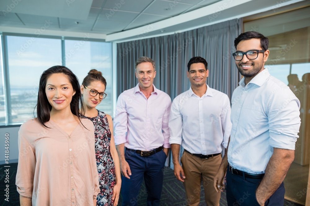 Portrait of smiling business colleagues standing together Portrait of smiling business colleagues standing together