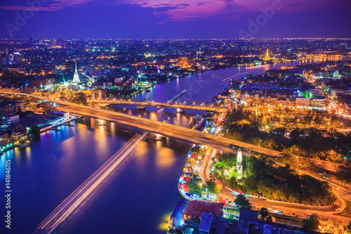 Bangkok city skyline and Chao Phraya River under twilight evening sky. © amthinkin