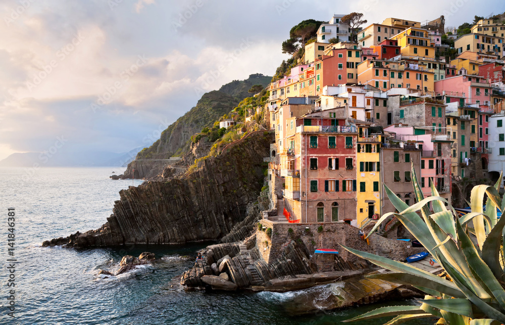 Beautiful town of Riomaggiore - the first of the Five Lands of the Italian National Park Cinque Terre the Ligurian coast in the sunset