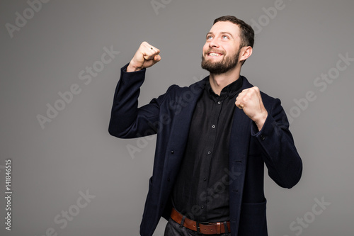 Handsome young businessman gesturing and smiling photo