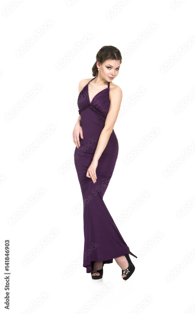 A young,smiling girl in dress posing on a white background. Studio shot, isolated image. A young,smiling girl in dress posing on a white background. Studio shot, isolated image.