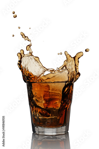 Splash in glass of scotch whiskey with ice