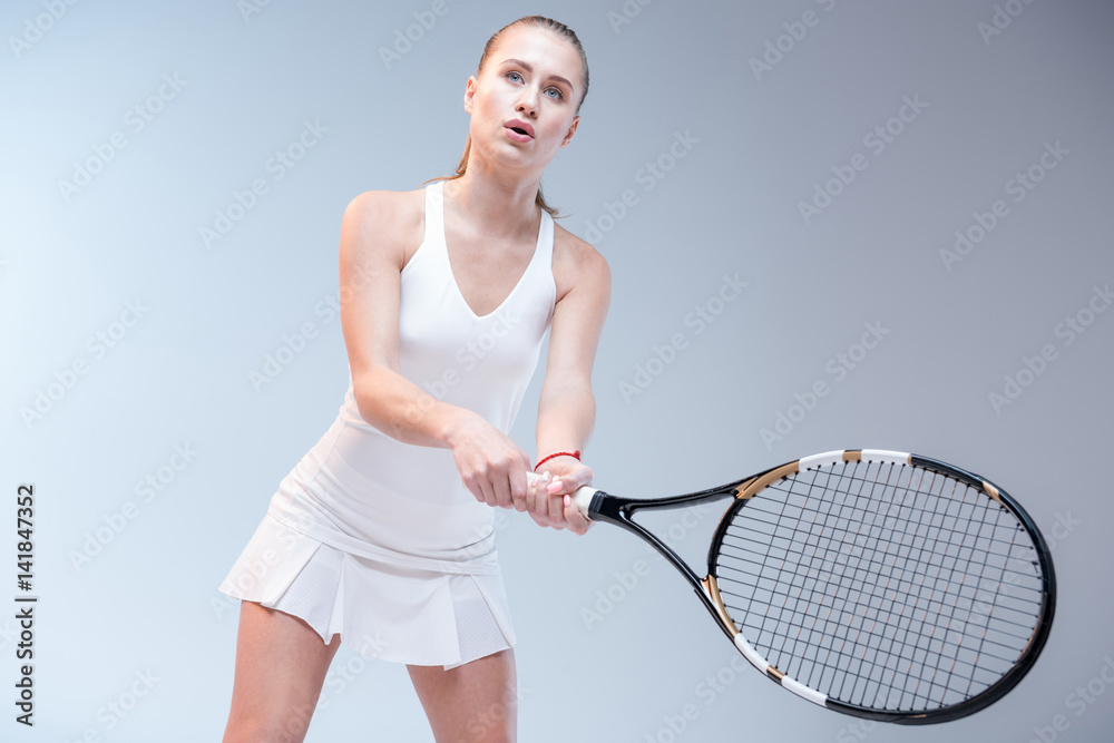 Fototapeta premium Young woman playing tennis
