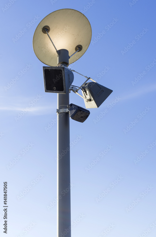 Street light and speaker with a sky background