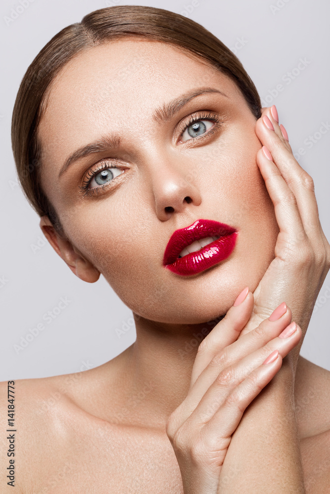Beautiful young model with red lips and nude manicure Beautiful young model with red lips and nude manicure