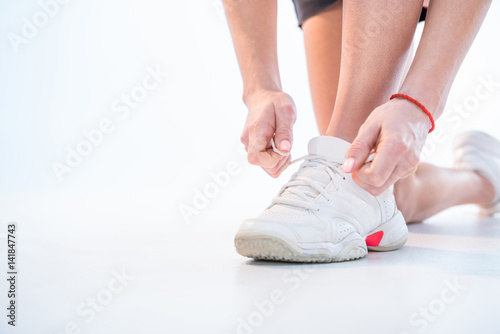 woman tying shoelaces