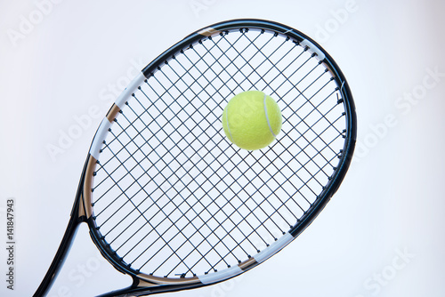 tennis racket with ball © LIGHTFIELD STUDIOS