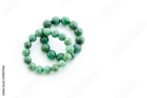 Beautiful valuable Emerald stone beads in bracelet on white background