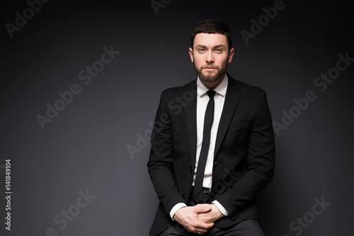 Elegant man close up portrait against dark background.