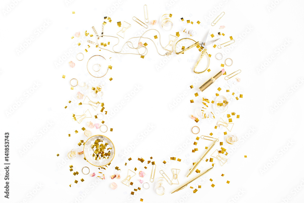 Beauty blog background. Gold style feminine accessories frame. Golden tinsel, scissors, pen, rings, necklace, bracelet on white background. Flat lay, top view.