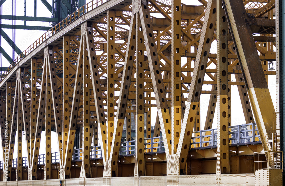 Close angled view of orange metal lift bridge, detail in beams and steel construction Close angled view of orange metal lift bridge, detail in beams and steel construction