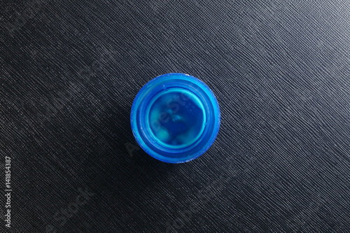 The dirty blue color plastic detergent bottle cap represent the bottle and containing packaging concept related idea.