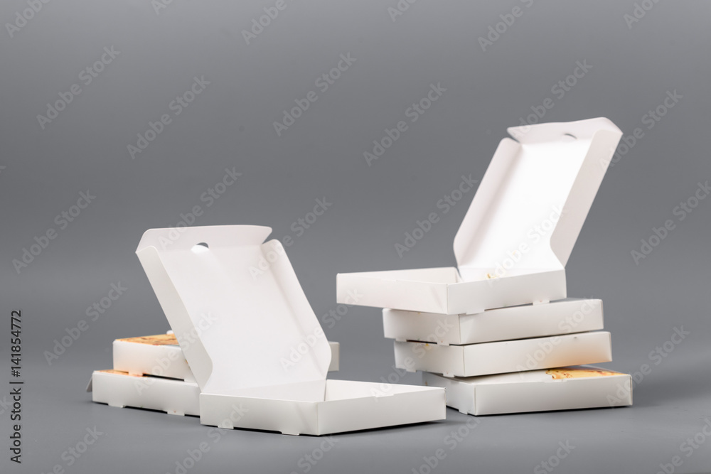 Pizza boxes on a gray background. Isolate - obrazy, fototapety, plakaty 