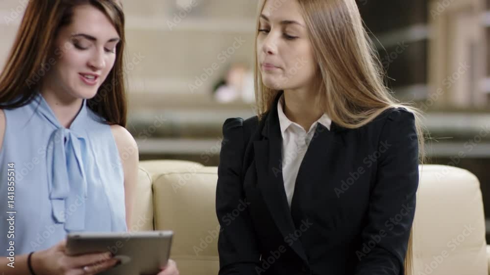 female businesspartners working with tablet and having success female businesspartners working with tablet and having success
