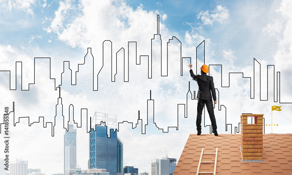 Man architect draw silhouette of modern city on blue sky. Mixed media Man architect draw silhouette of modern city on blue sky. Mixed media