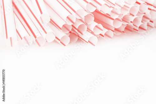 Red and white drinking straws on the white - studio shot