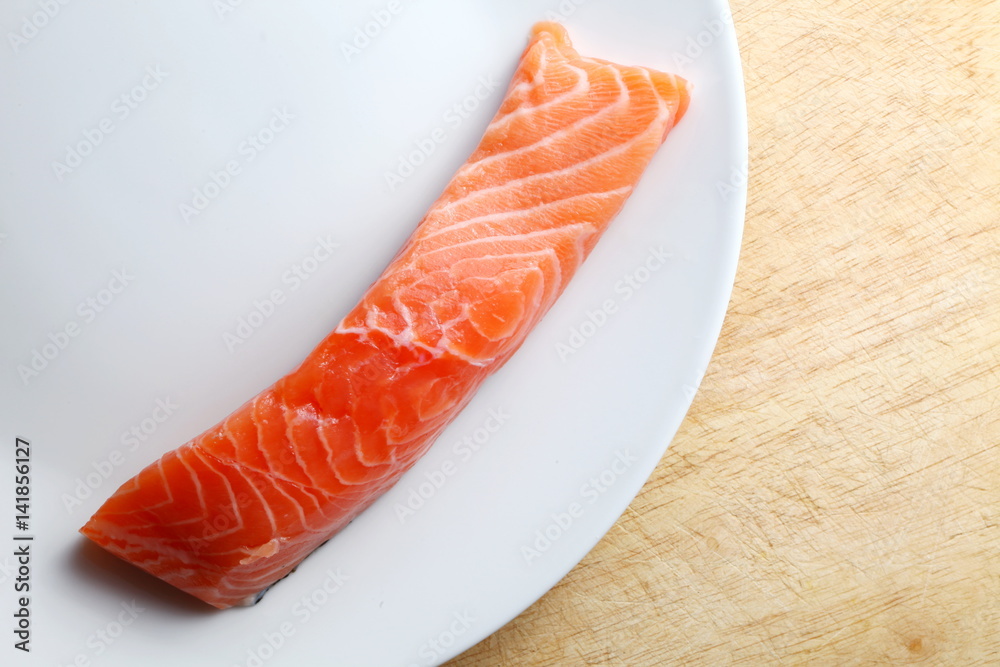 The fresh fillet salmon fish on white plate represent the food concept related idea. The fresh fillet salmon fish on white plate represent the food concept related idea.