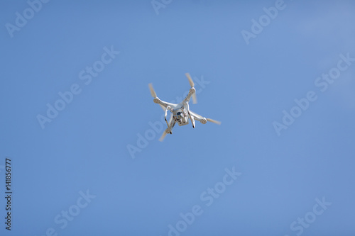 Drone hover flying with camera recoard lens against blue sky aerial photography