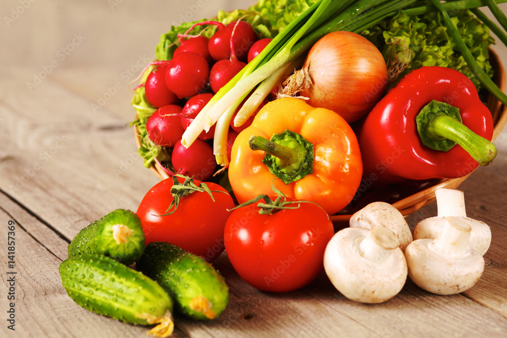 Composition with assorted raw organic vegetables wooden table