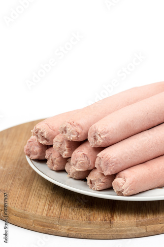 Cooked hot dogs served on the plate over white background