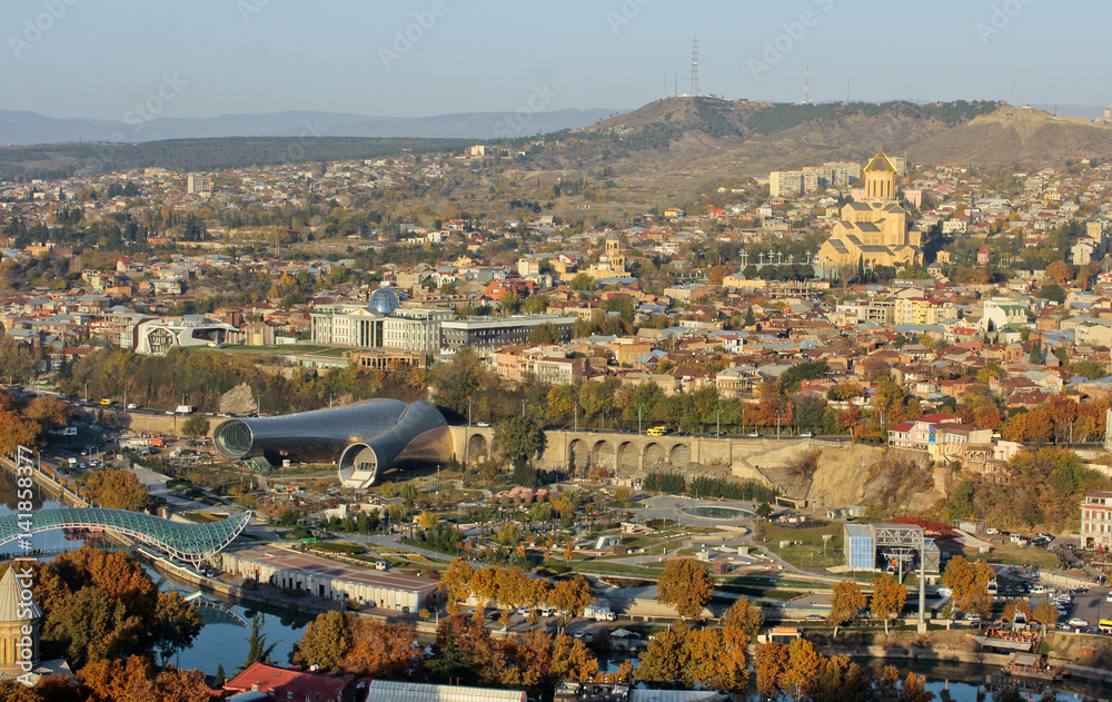 Autumn view to historical part of the capital of Republic of Georgia. In front is Europe Square, then Presidential Palace. The Holy Trinity Cathedral of Tbilisi at the right corner.