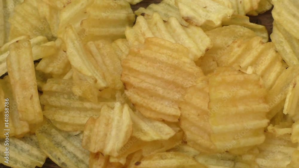 Rippled potato chips on a wooden background
Rippled potato chips on a wooden background
