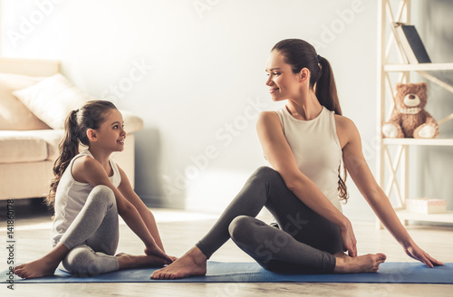 Mom and daughter doing yoga