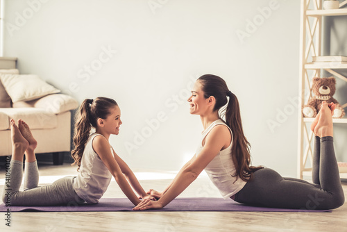 Mom and daughter doing yoga