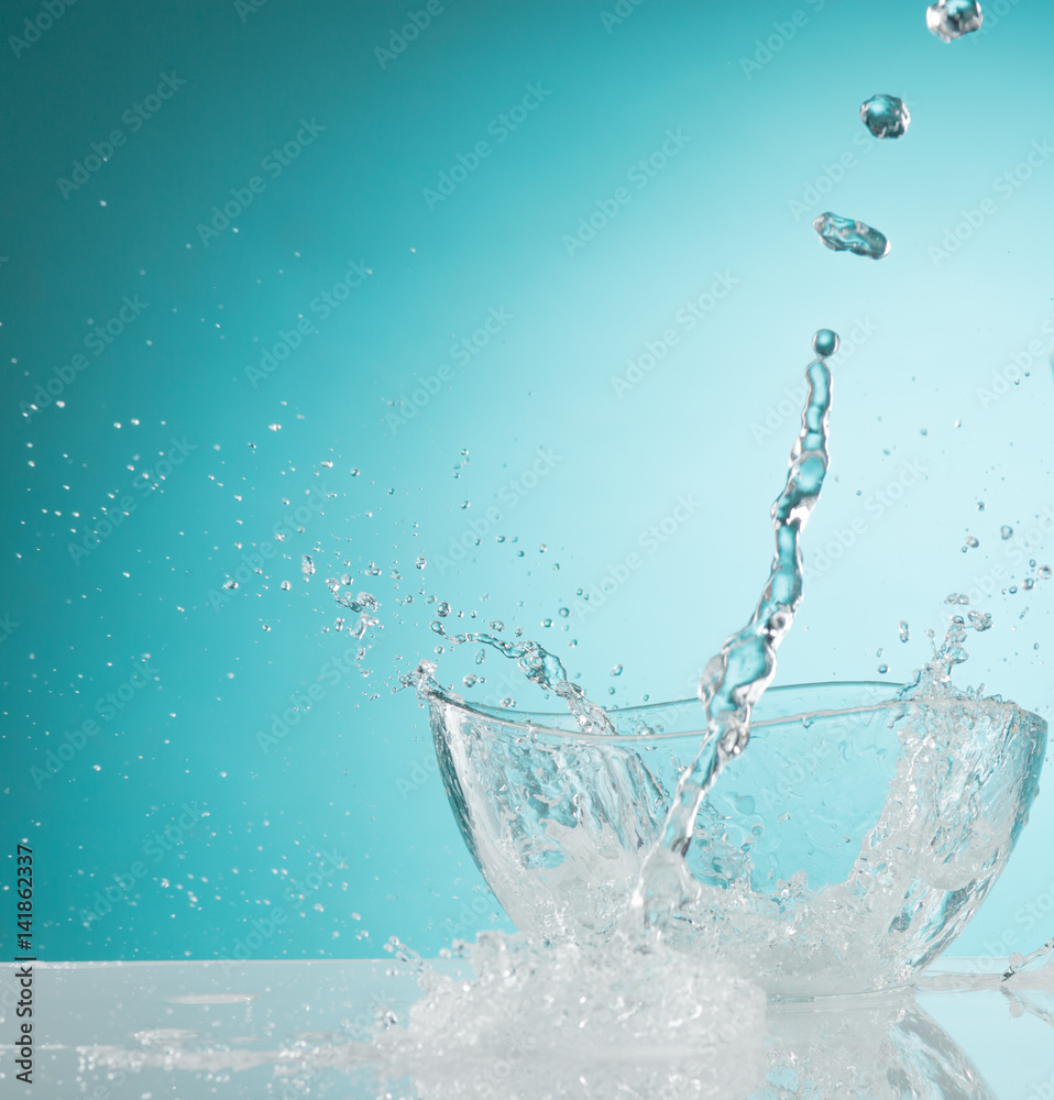 The water splashing to glass bowl on white background Stock-Foto