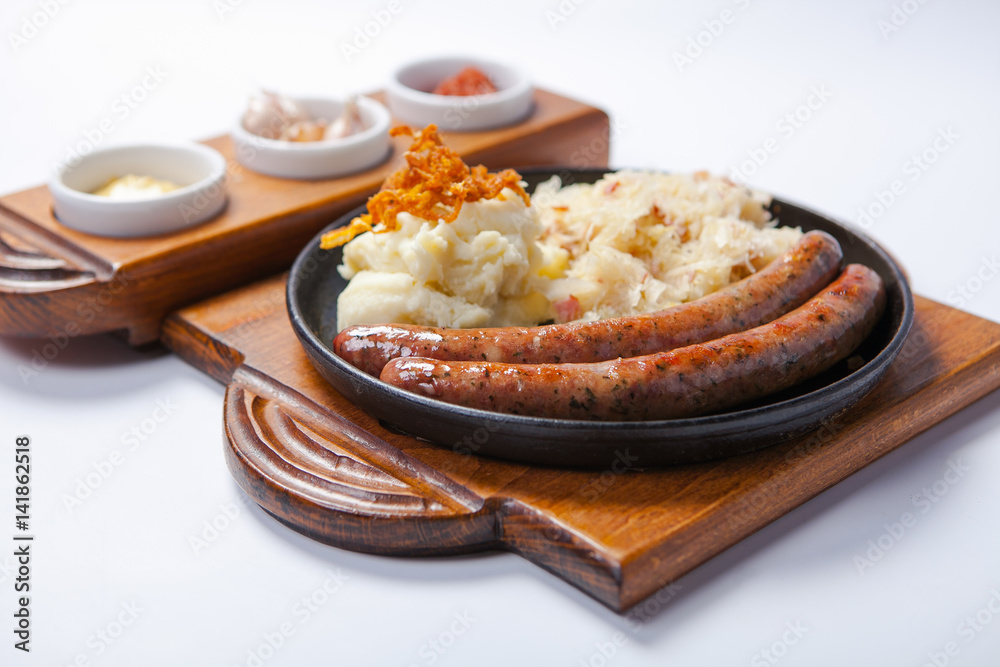 grilled sausages, and potatoes on cooking pan