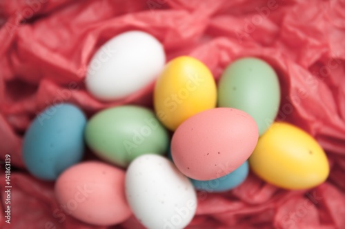 Easter eggs piled up on a red background