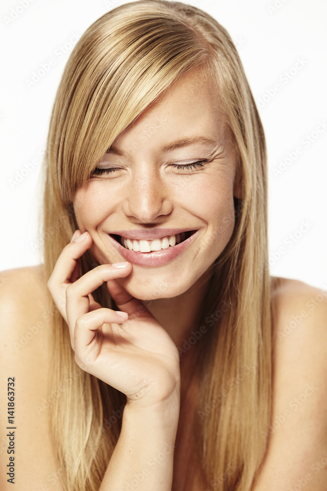 Laughing blond woman with eyes closed, close up Laughing blond woman with eyes closed, close up