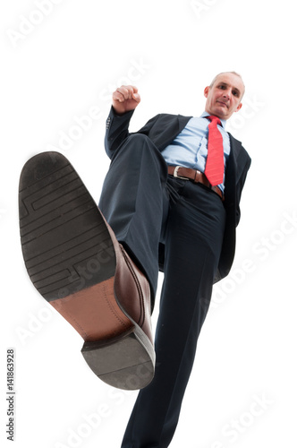 Low angle of business man stepping on camera