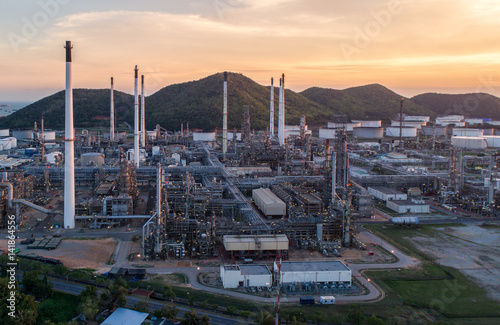 Aerial view Oil refinery with a background of mountains and sky.The factory is located in the middle of nature and no emissions. The area around the air pure. © MAGNIFIER
