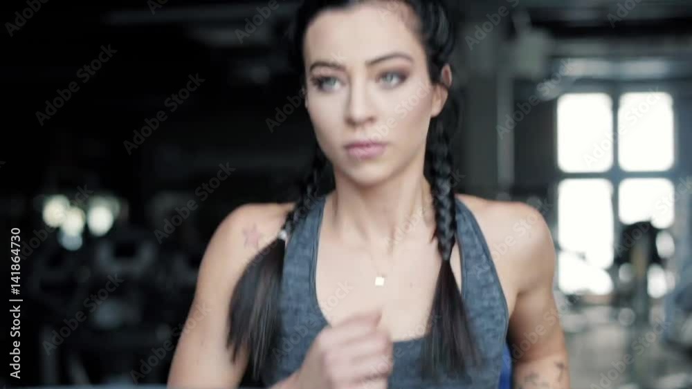 Confident woman training on running machine Confident woman training on running machine