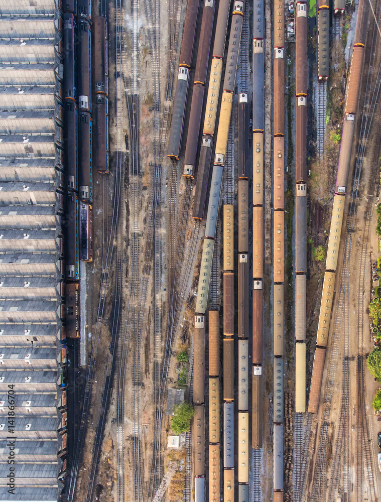 Obraz premium Freight and passenger train waiting at the train station parking lot.Cargo transit.import export and business logistic.Aerial view.Top view.