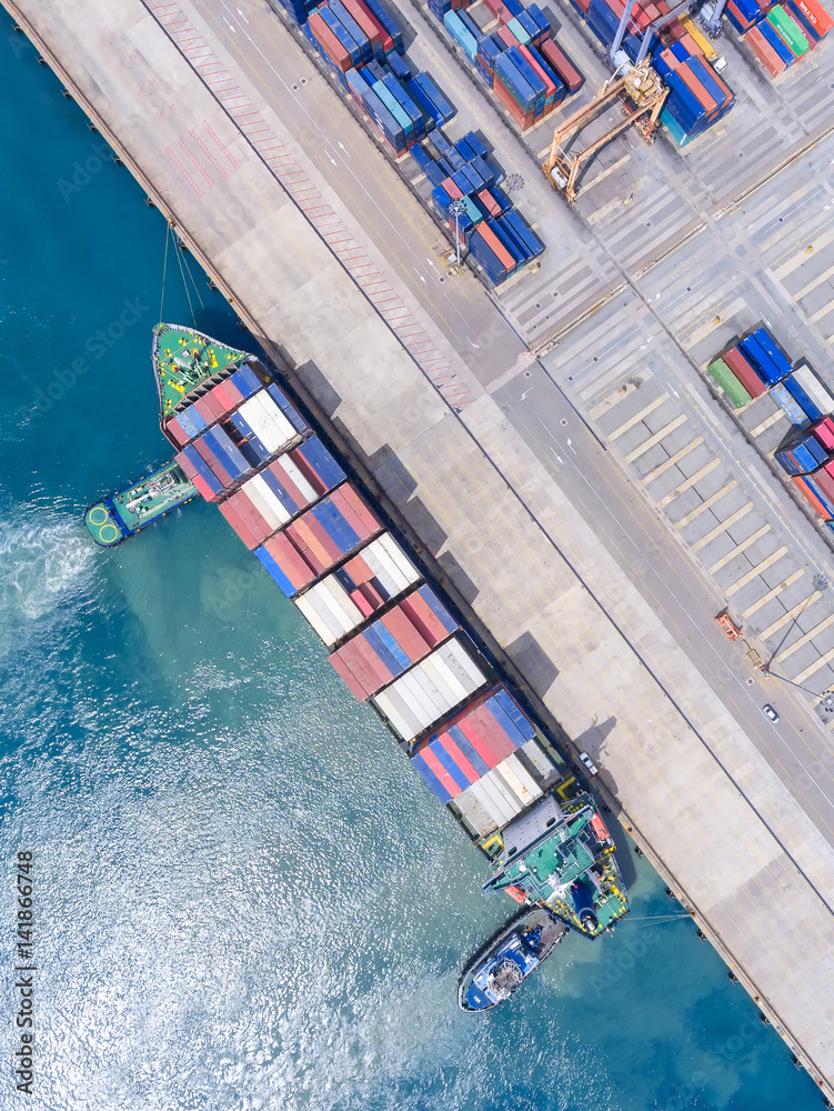 container ship in import export and business logistic.By crane ,Trade Port , Shipping.cargo to harbor.Aerial view.Water transport.International.Shell Marine.Top view.