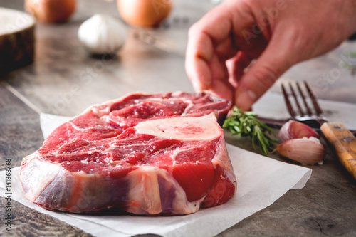 Preparing meat plate on wooden background 