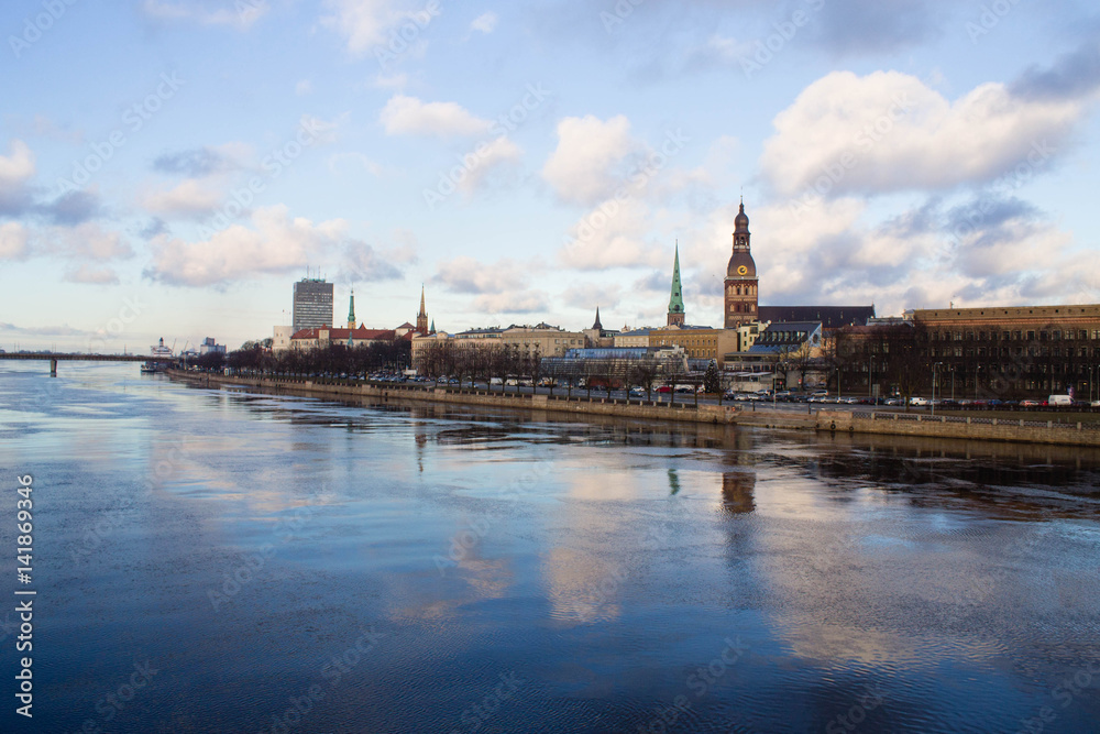 Fototapeta premium Sunset light over bridge and river in Riga, Latvia