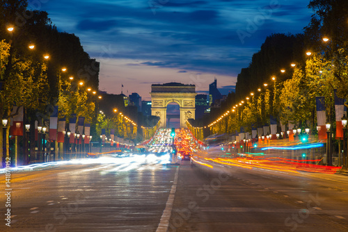 Night view of Paris traffic in Champs-Elysees street and the Arc de Triomphe in Paris, France. © ake1150