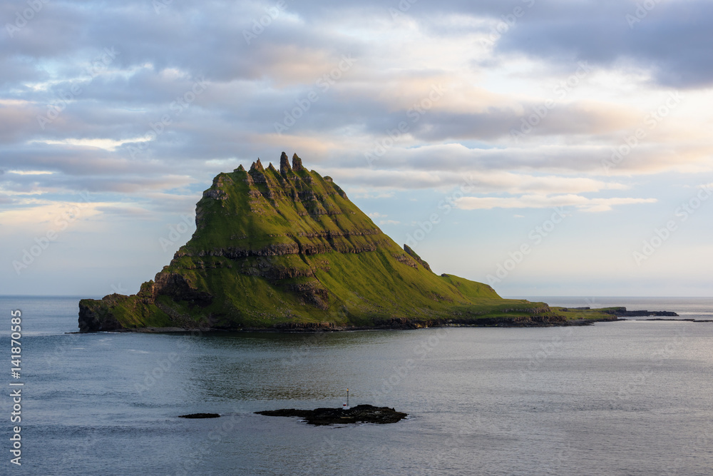 Scenic view of Tinholmur islet against cloudy sky during sunset Scenic view of Tinholmur islet against cloudy sky during sunset