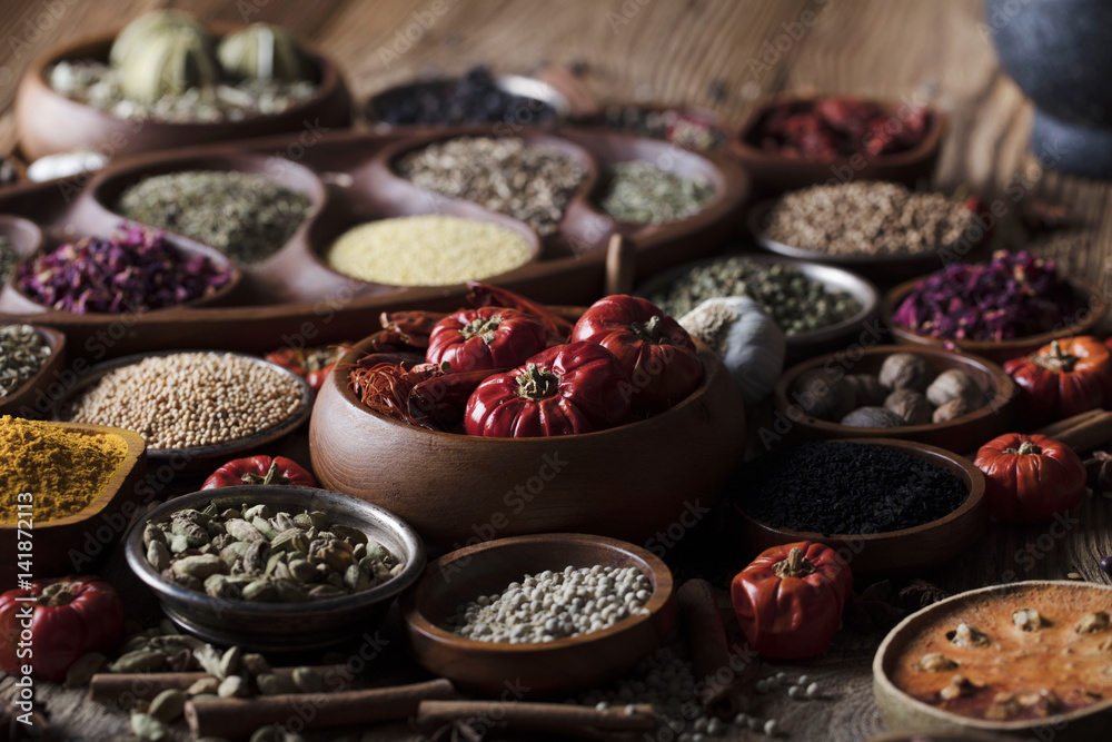 various dry spices on a wooden table