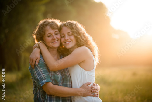 Daughter and mother hugging each other