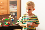 Little boy playing with toys having fun
