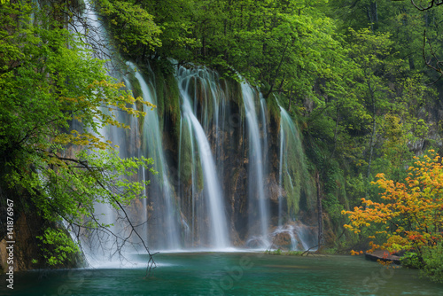 Waterfall, lake and orange tree